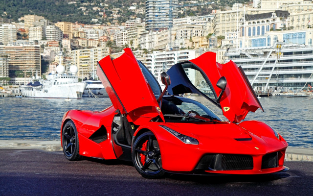 Red sports car waterfront cityscape free wallpaper - medium preview image