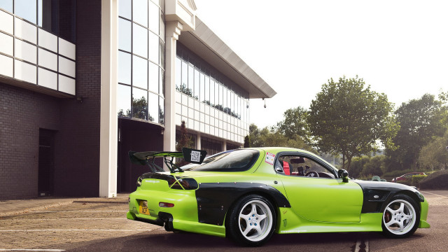 Green car building bike rack free wallpaper - medium preview image