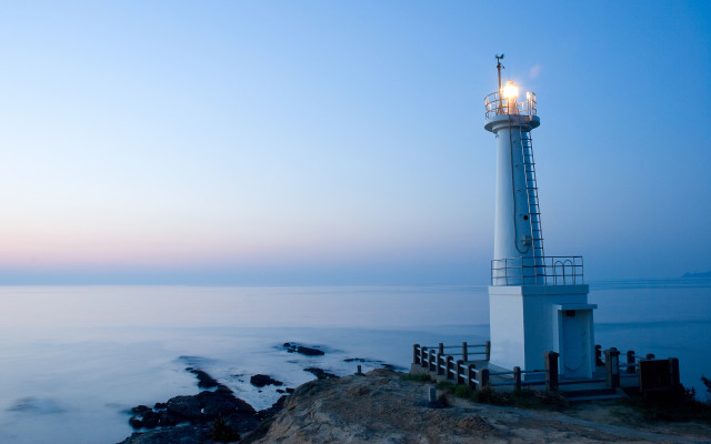 Lighthouse rocky cliff ocean dusk free wallpaper - medium preview image