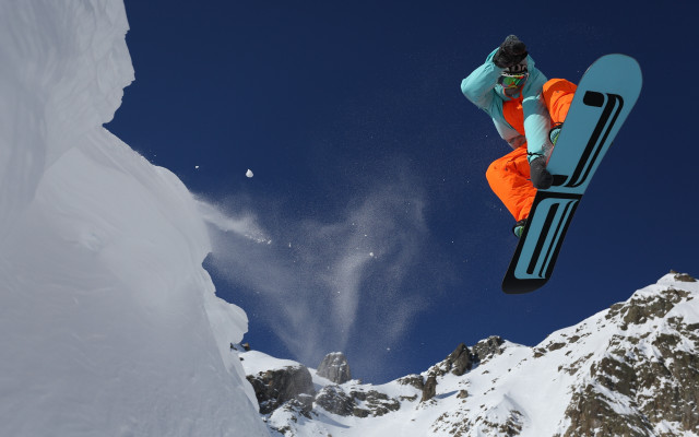 Snowboarder orange pants trick mountain free wallpaper - medium preview image