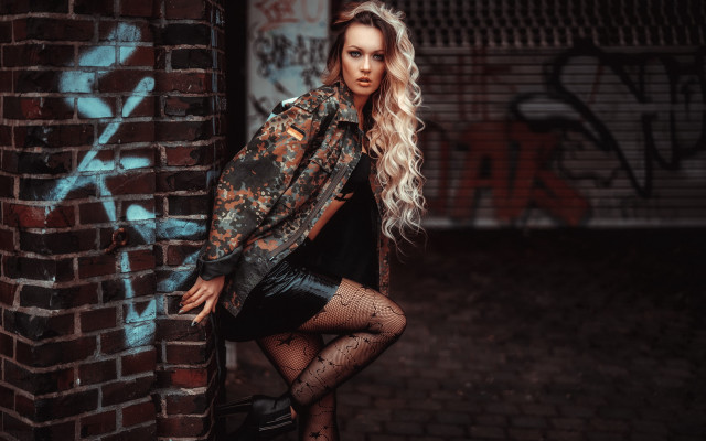 Woman leaning brick wall graffiti free wallpaper - medium preview image