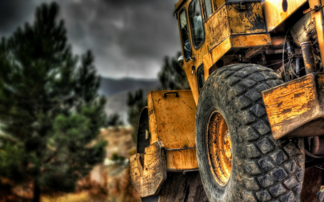 Yellow truck wooded area blurry free wallpaper - medium preview image