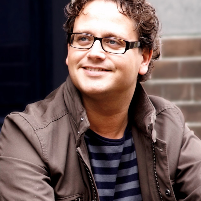 Man glasses smiling brick building free wallpaper - medium preview image