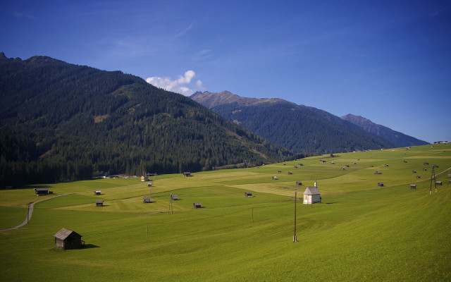 Green field mountain houses blue free wallpaper - medium preview image