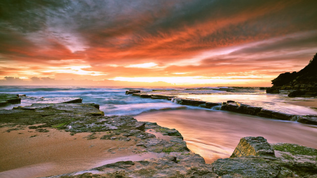 Sunset rocky beach water cityscape free wallpaper - medium preview image
