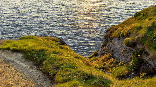 Grassy cliff path water boat free wallpaper - medium preview image