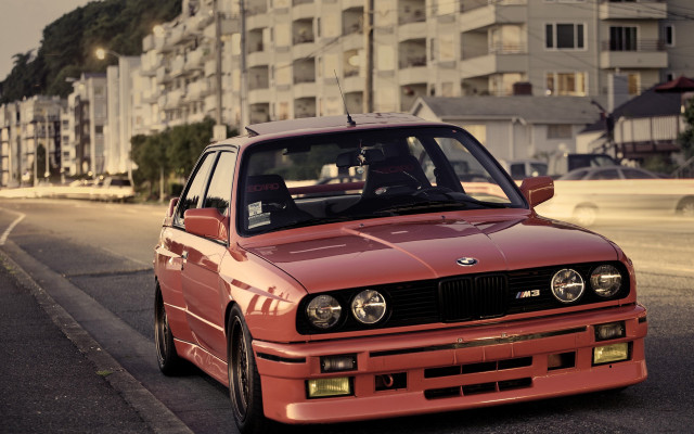 Red car tall building cityscape free wallpaper - medium preview image