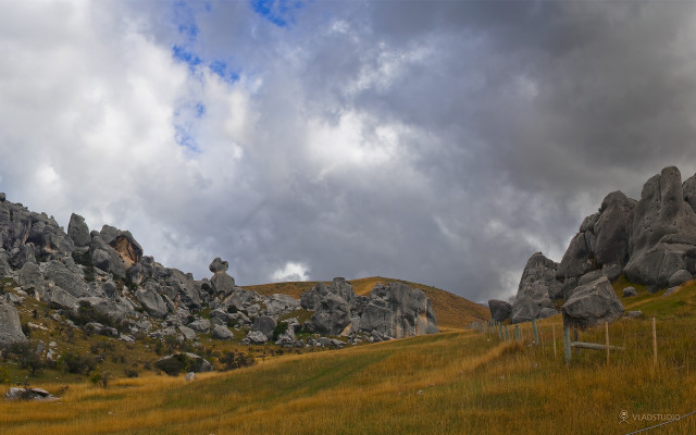 Grassy field rocks fence cloudy free wallpaper - medium preview image