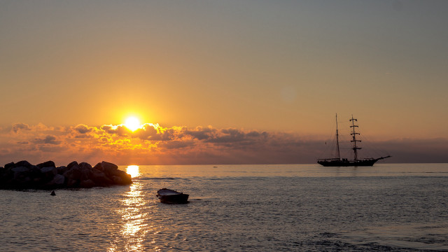 Boat ocean sunset rock mountain free wallpaper - medium preview image