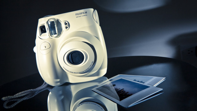 White camera on table with free wallpaper - medium preview image