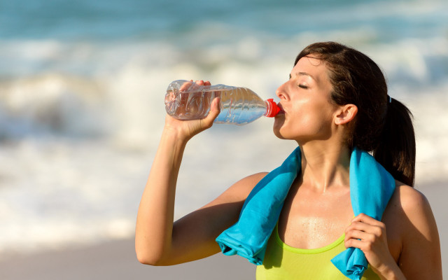 Woman drinking beach towel water free wallpaper - medium preview image