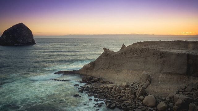 Rocky cliff water outcropping beach free wallpaper - medium preview image