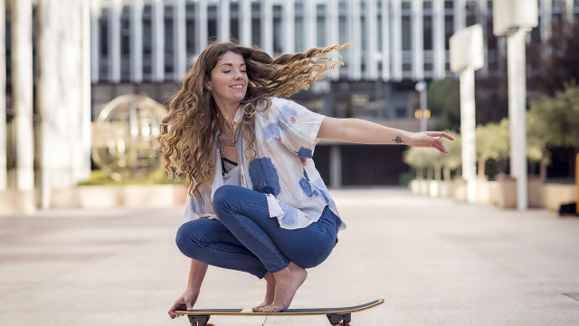 Skateboarder city clock building blurry free wallpaper - medium preview image