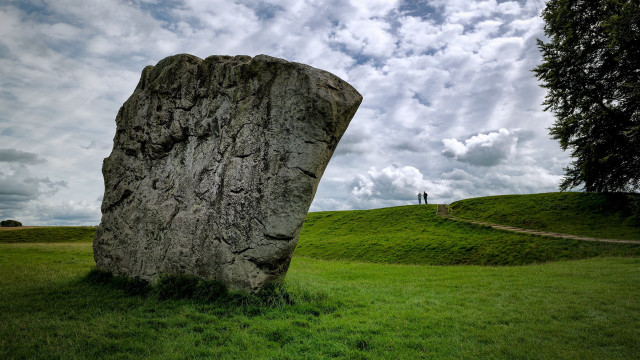 Large rock grassy field person free wallpaper - medium preview image