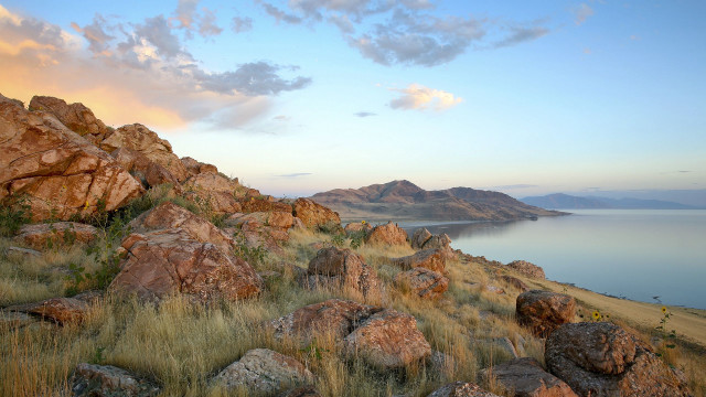 Rocky hillside lake clouds grass free wallpaper - medium preview image