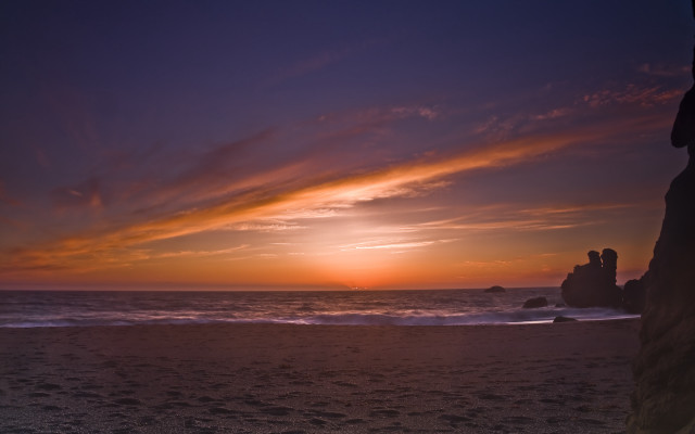 Sunset ocean couple rock beach free wallpaper - medium preview image