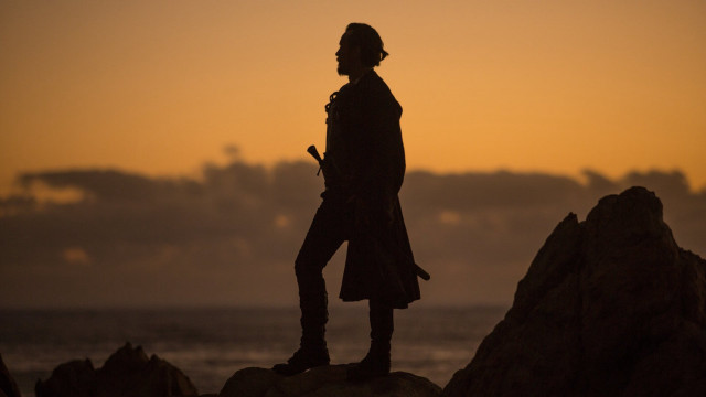 Man rock ocean sunset city free wallpaper - medium preview image