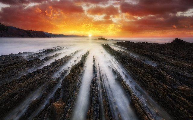 Sunset rocky beach water rocks free wallpaper - medium preview image