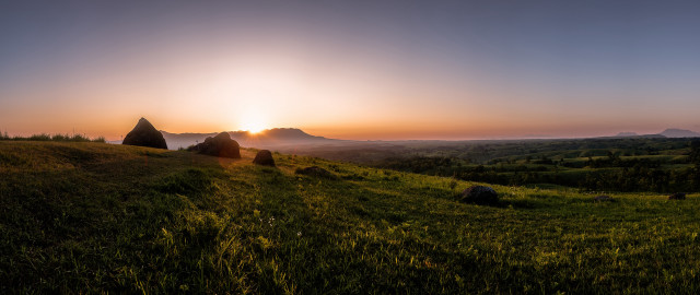 Grassy hill sunset rocks trees free wallpaper - medium preview image