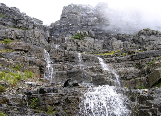 Waterfall rocks foggy sky person free wallpaper - medium preview image