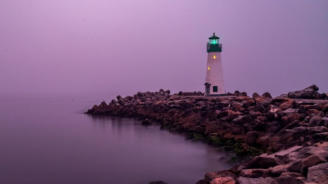 Lighthouse rocky shore green light free wallpaper - medium preview image