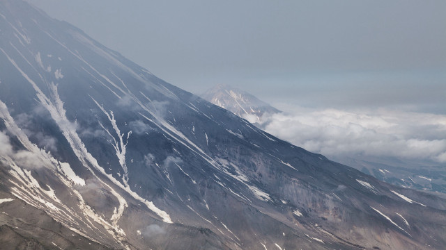 Mountain peak plane clouds ocean free wallpaper - medium preview image