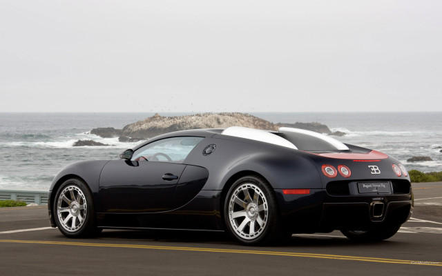 Black sports car ocean rock free wallpaper - medium preview image