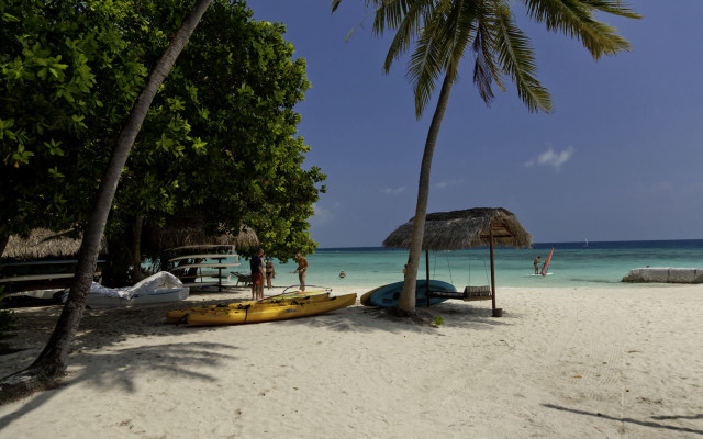 Beach umbrella kayaks people sky free wallpaper - medium preview image