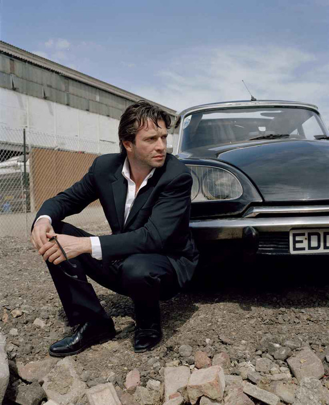 Man suit car rocky ground free wallpaper - medium preview image