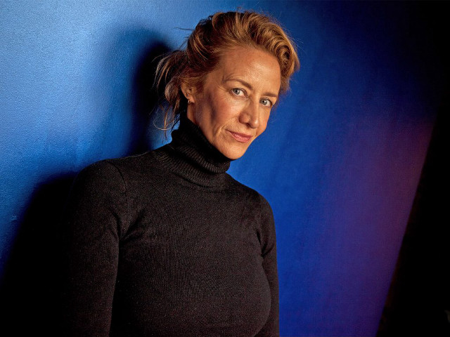 Woman black turtleneck blue wall free wallpaper - medium preview image