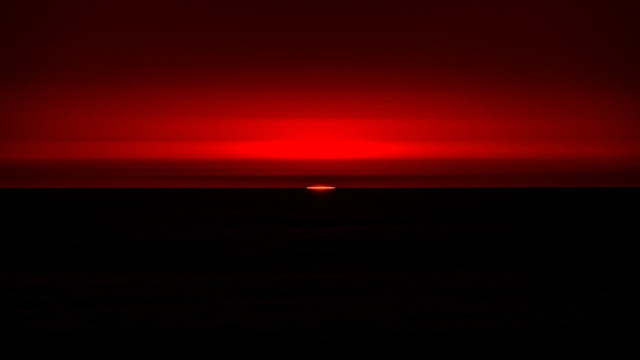 Red sky sunset ocean boat free wallpaper - medium preview image