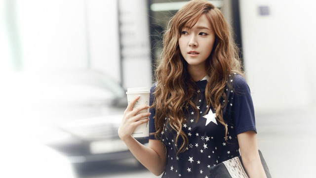 Woman holding coffee looking camera free wallpaper - medium preview image