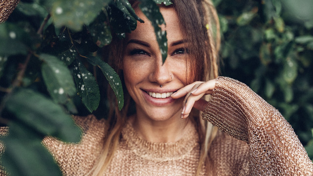 Woman smiling greenplant portrait photorealistic free wallpaper - medium preview image