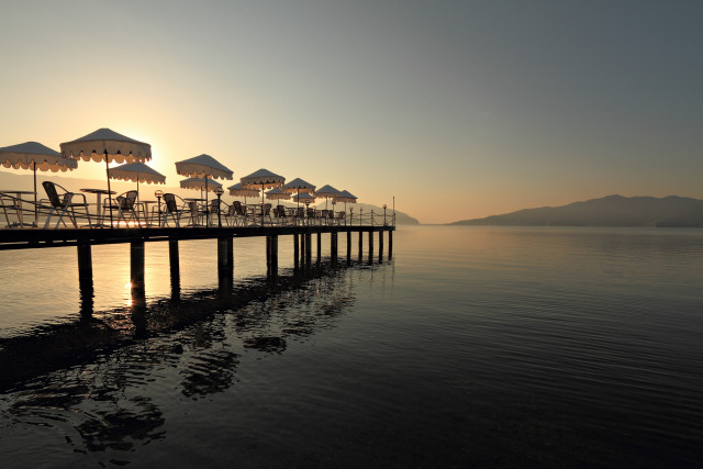 Pier umbrellas chairs sunset bridge free wallpaper - medium preview image