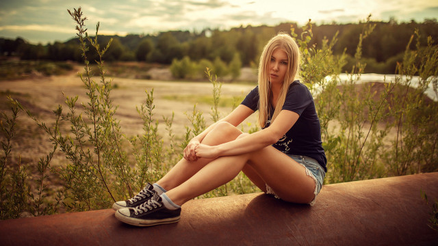 Woman sitting ledge river outdoors free wallpaper - medium preview image