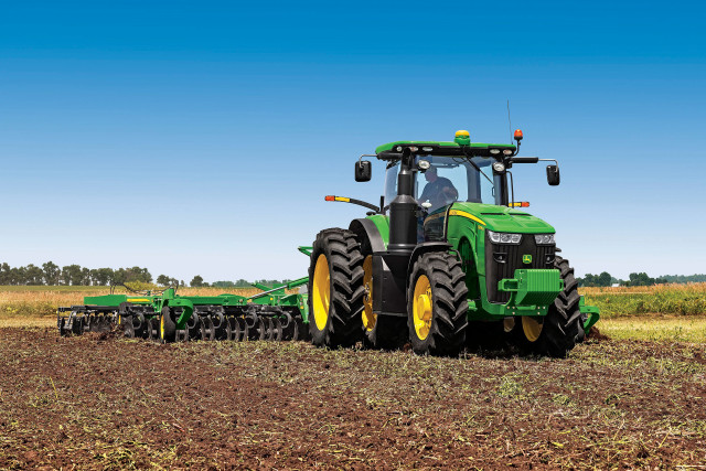 Tractor plowing field green yellow free wallpaper - medium preview image