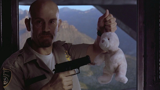 Man holding stuffed animal pointing free wallpaper - medium preview image