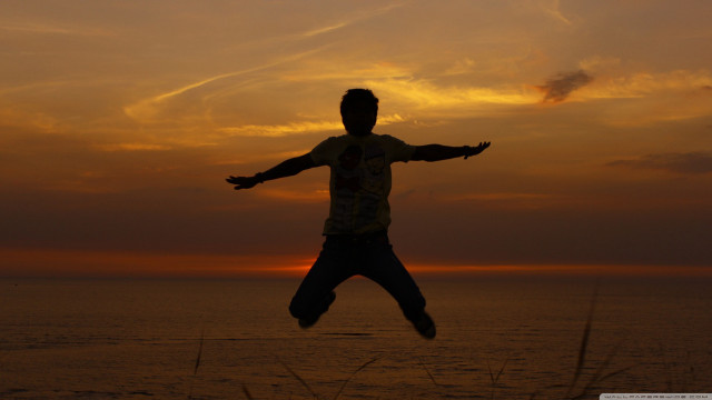 Man jumping sunset arms outstretched free wallpaper - medium preview image
