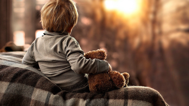 Boy sitting on couch with free wallpaper - medium preview image