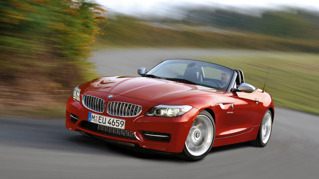Red convertible driving forest hills free wallpaper - medium preview image