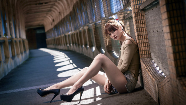 Woman highheels greenshirt sitting wall free wallpaper - medium preview image