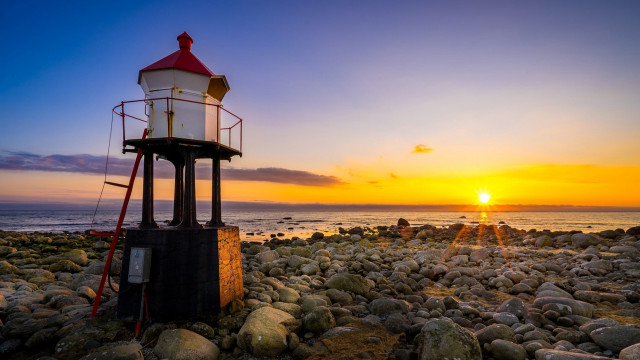 Lighthouse rocky beach sunset ocean free wallpaper - medium preview image