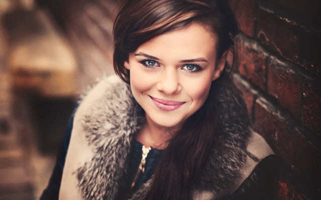 Woman smiling fur collar brick free wallpaper - medium preview image