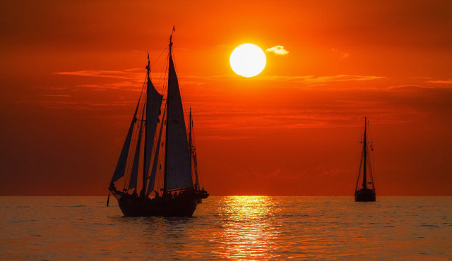 Sailboat ocean sunset mountain clouds free wallpaper - medium preview image