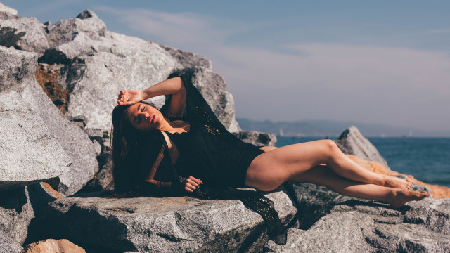 Woman rocks ocean crossed olive free wallpaper - medium preview image