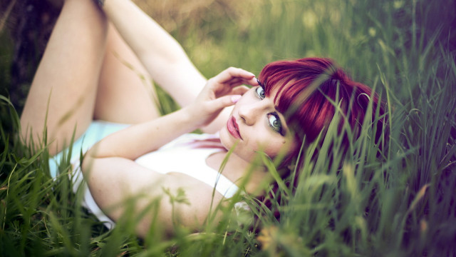 Woman lying in grass blooming free wallpaper - medium preview image