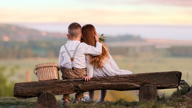 Couple sitting on log with free wallpaper - medium preview image