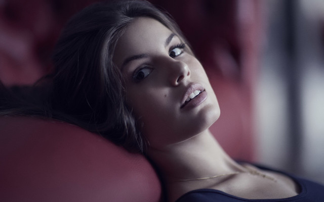 Woman laying red couch portrait free wallpaper - medium preview image