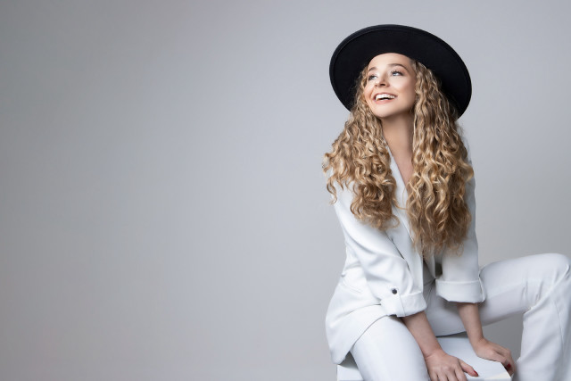 Woman blonde hat sitting blue free wallpaper - medium preview image