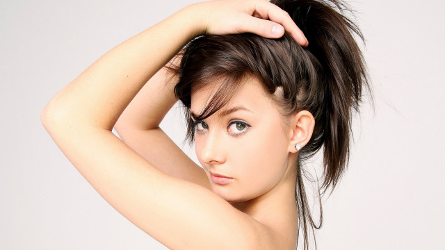 Woman messy topknot posing evaline free wallpaper - medium preview image